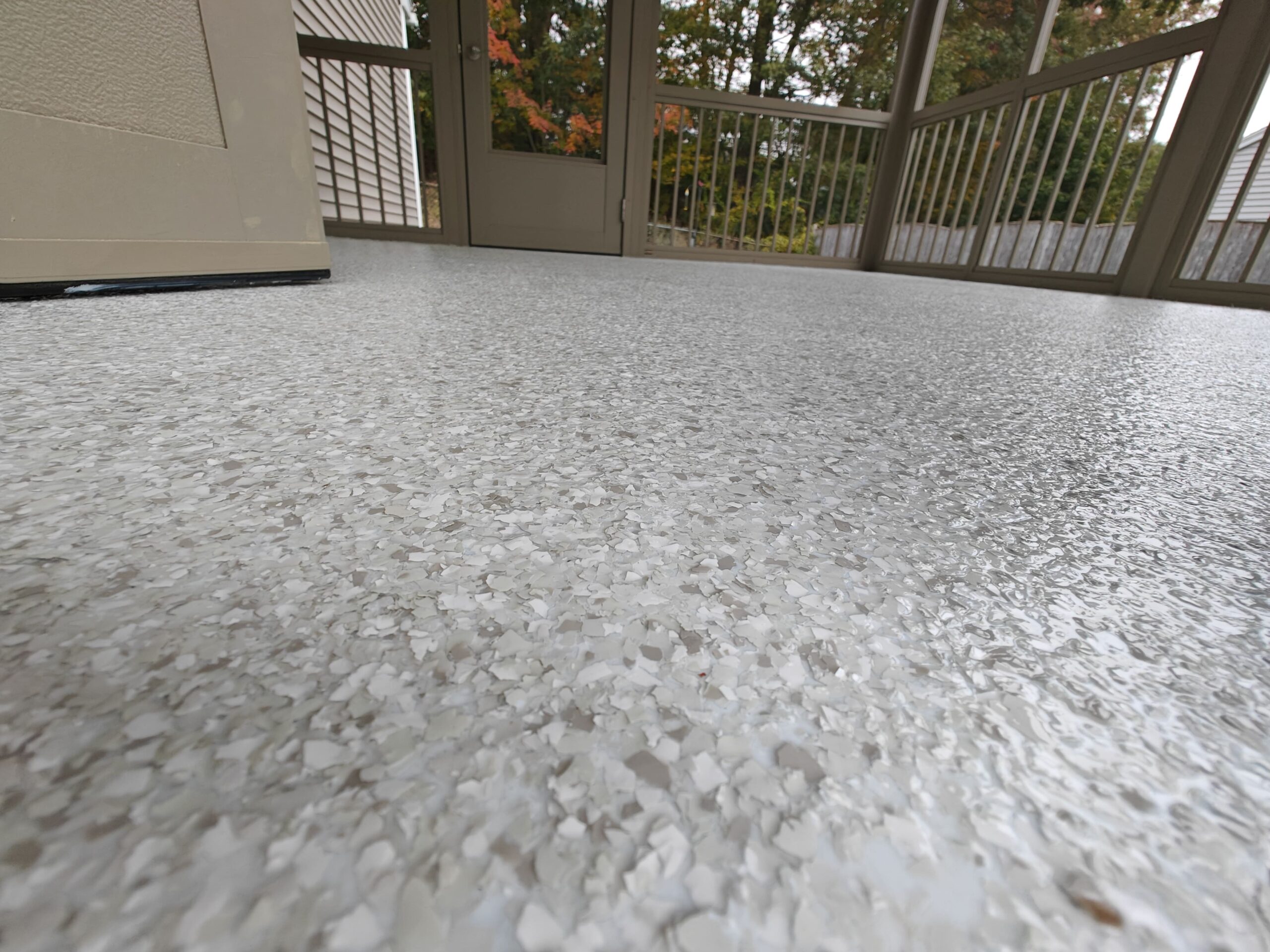 best concrete contractor residential concrete coating Swan Flake over plywood base on this screened in porch in Mandeville LA-min